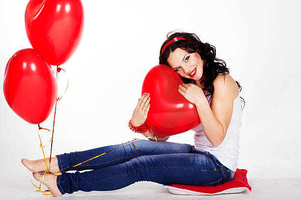 istock valentine's day  woman with red balloons 461848165