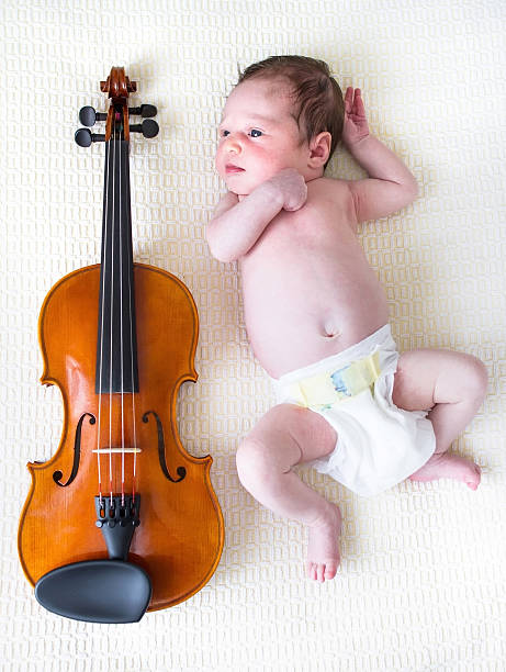 istock Newborn baby next to a violin 461855795