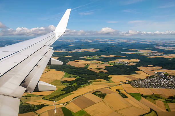 istock Aerial view of plane wing and fields 461860171