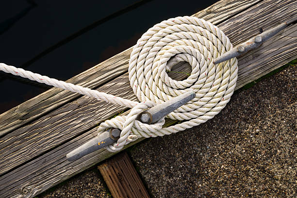 Beautiful Swirled Curled Rope Boat Bow Line Nautical Tie Down A detail oriented loving boat own makes his rig impeccable all the way around moored stock pictures, royalty-free photos & images