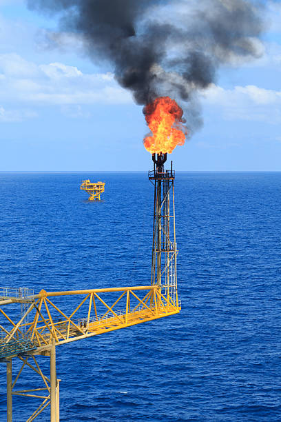istock Hot flare boom and fire on offshore production platform 461866111