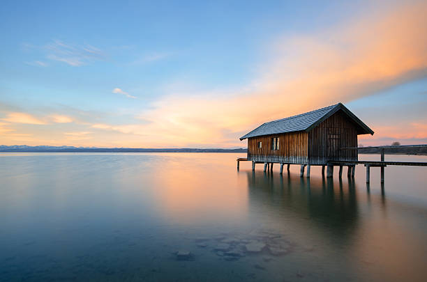 Traditional boathouse at lake Ammersee at sunrise.