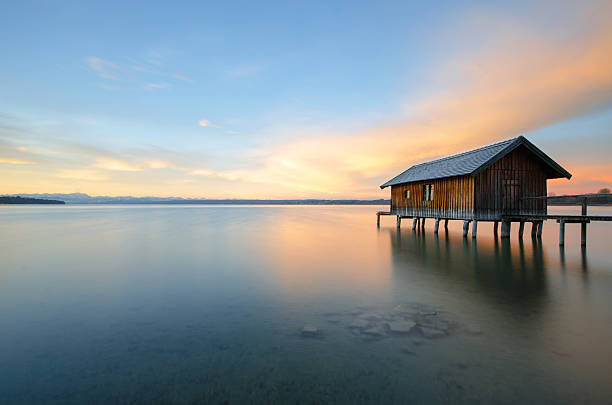 Traditional boathouse at lake Ammersee at sunrise.