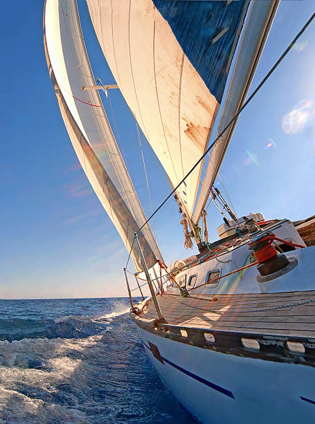 Close up view of a sailing yacht boat on the ocean Sailing boat in blue open sea sailboat sports race yachting yacht stock pictures, royalty-free photos & images