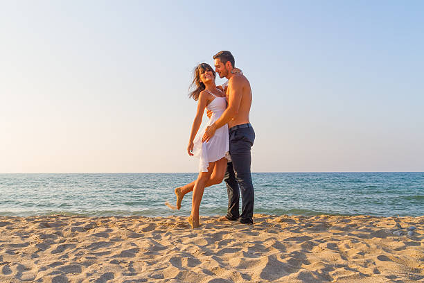 istock Young couple teasing one another at the beach 461887009