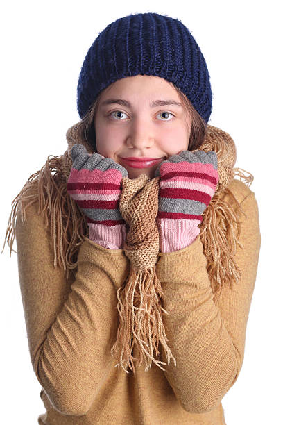 Young girl wearing winter wear and getting cold. Isolated on white