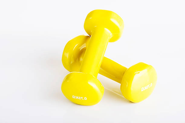 黄色光沢のあるダンベル - body building human muscle gym professional sport ストックフォトと画像