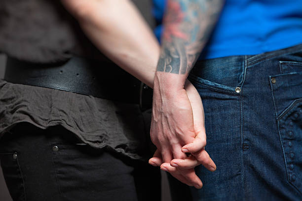 istock Closeup of holding hands from young couple. 461891577
