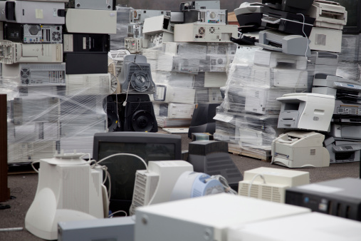 Stacks of electronic equipment in a recycling facility.
