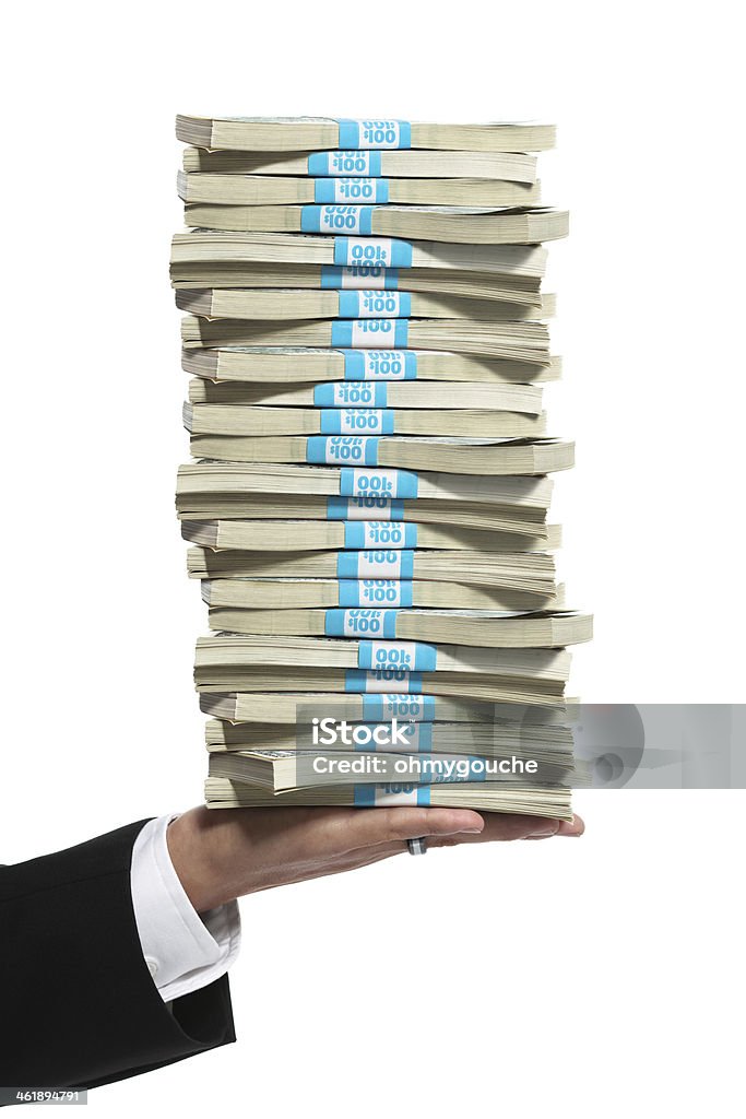 Business man hand holding a tall stack of money Business man hand holding a stack of cash Stack Stock Photo