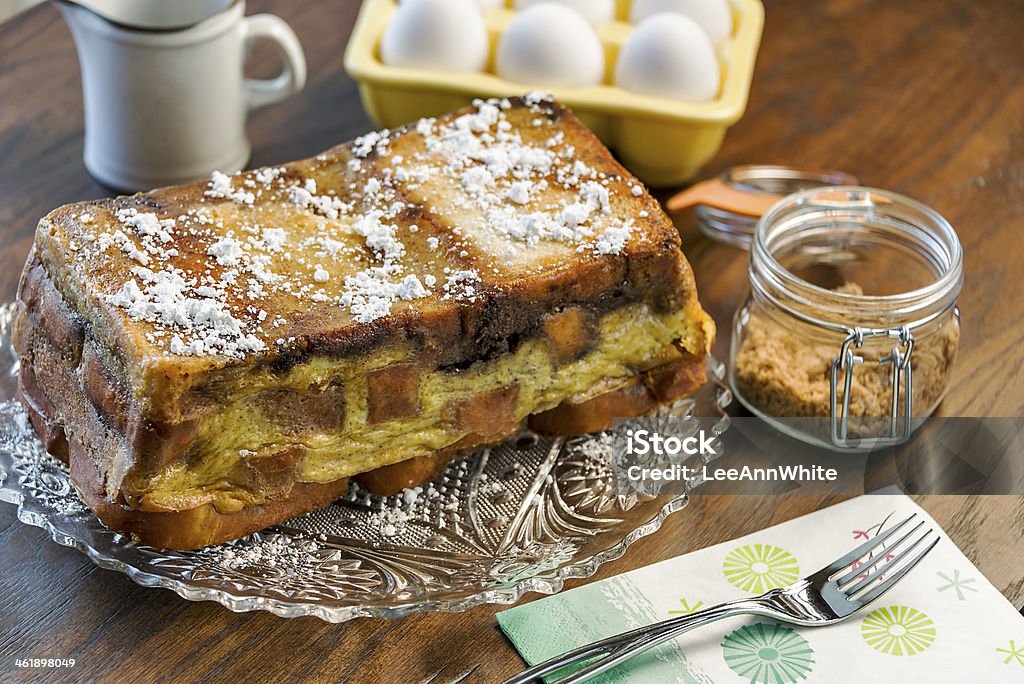 French Toast Loaf A rich freshly baked French Toast loaf is served with extra brown sugar and syrup. Baked Stock Photo