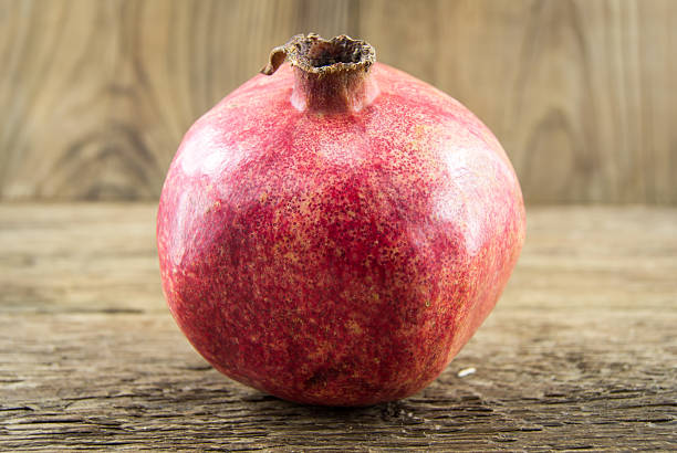 istock Pomegranate isolated on wooden background 461904001