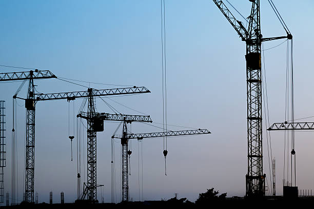 istock Silhouettes of construction cranes 461906037
