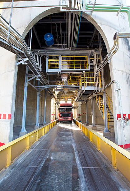 istock Truck loading a product under factory silo 461906531