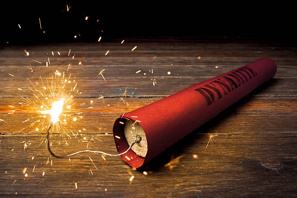 dynamite stick on a wooden floor Dynamite on a dark background explosive photos stock pictures, royalty-free photos & images