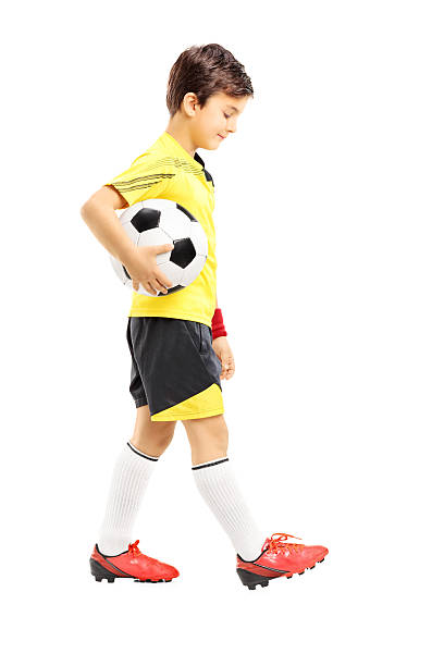 istock Sad kid in sportswear posing with a ball 461916979