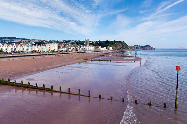 istock Teignmouth beach Devon England UK with blue sky 461923033