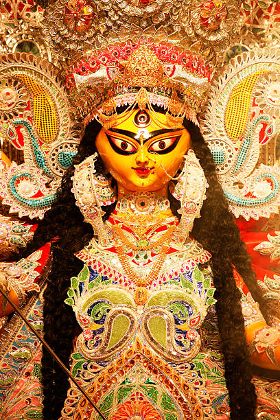 Durga Puja Festival Durga Puja - the ceremonial worship of the mother goddess, is one of the most important festivals of India. Apart from being a religious festival for the Hindus, it is also an occasion for reunion and rejuvenation, and a celebration of traditional culture and customs. While the rituals entails ten days of fast, feast and worship, the last four days - Saptami, Ashtami, Navami and Dashami - are celebrated with much gaiety and grandeur in India and abroad, especially in Bengal, where the ten-armed goddess riding the lion is worshipped with great passion and devotion. durga stock pictures, royalty-free photos & images
