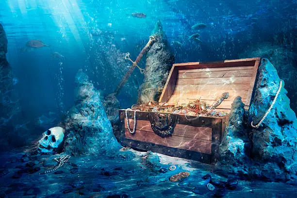wooden treasure chest submerged underwater with light rays