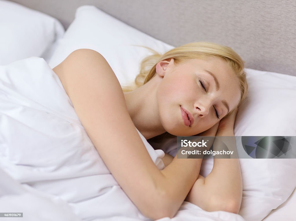 beautiful woman sleeping in bed hotel, travel and happiness concept - beautiful woman sleeping in bed Adult Stock Photo