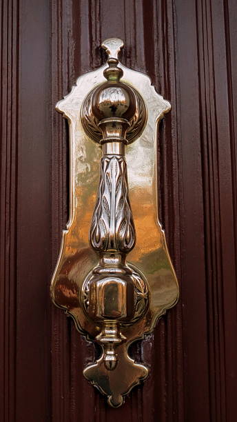 istock Door knocker shaped bottle on dark wood 461933865