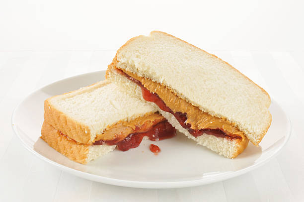 Peanut butter and jelly sandwich A peanut butter and jelly sandwich on a high key setting peanut butter and jelly sandwich stock pictures, royalty-free photos & images