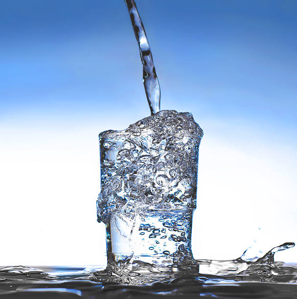 istock Glass with splashes of liquid overflowing the edges 461950673