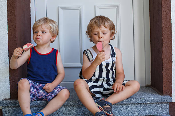 istock Two little biys boys eating ice cream 461954013
