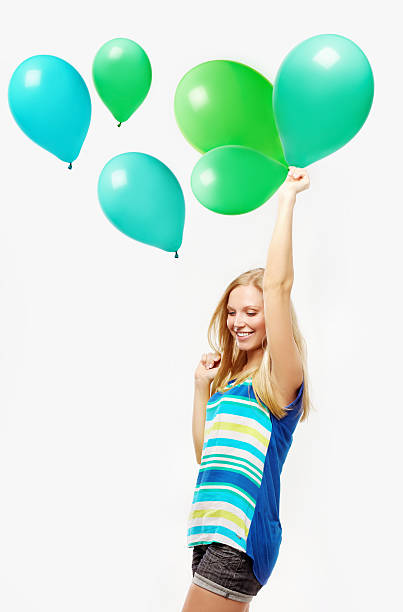 istock .Laughing young woman holding a balloon 461954577