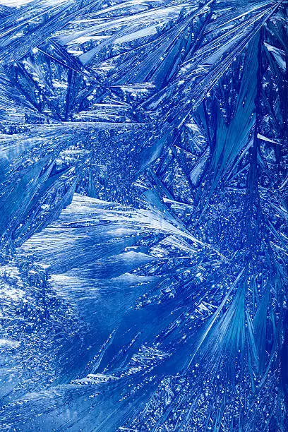 Abstract Winter background. Christmas abstract frostwork on a window glass