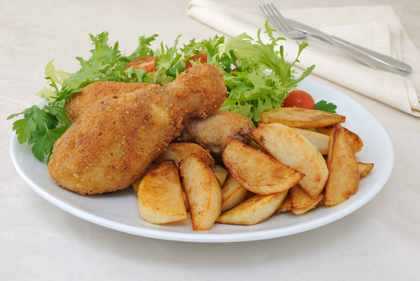 istock Chicken drumsticks with breadcrumbs  potatoes and salad 461956057