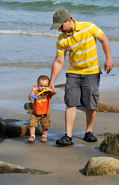 istock Father and Son Walking the Beach 461956431