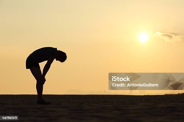 Silueta De Un Deportista Agotado En Puesta Foto de stock y más banco de imágenes de Agotamiento - Agotamiento, Correr, Calor