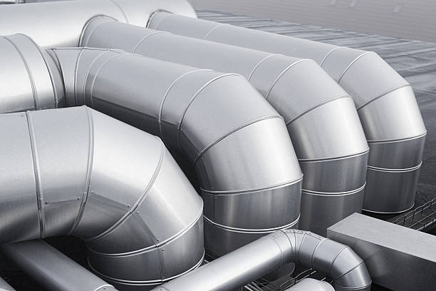 Group of pipes in a climate control system Industrial climate control. Group of tubes placed on the roof of an building. galvanized stock pictures, royalty-free photos & images