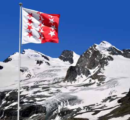 Strahlhorn,Rimpfischhorn and Allalinhorn with Wallis flag - Swiss Alps