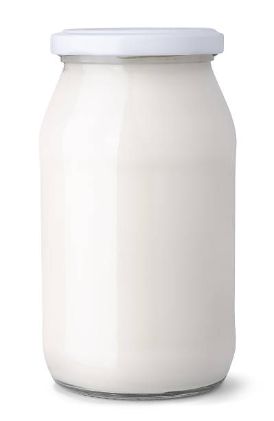 Dairy jar Glass jar of milk cream isolated on white jar of milk stock pictures, royalty-free photos & images