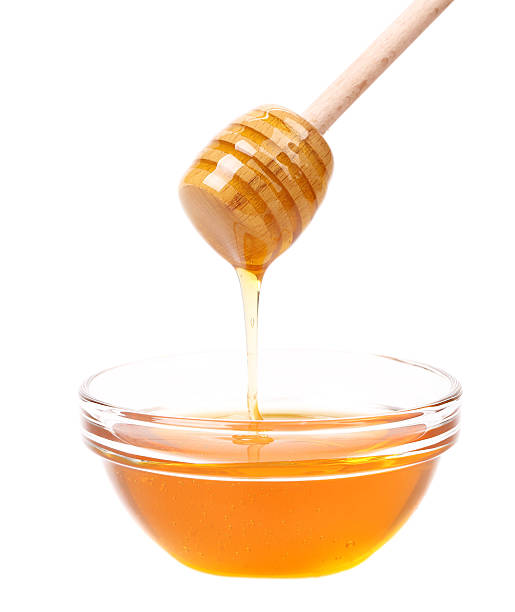 istock Bow of honey and wooden spoon. 461971991