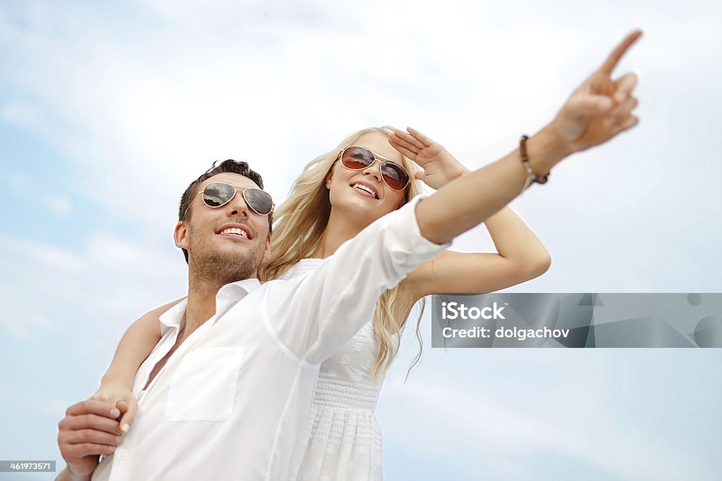 happy couple over sky summer holidays, people, love and dating concept - happy couple over sky  Animal Stock Photo