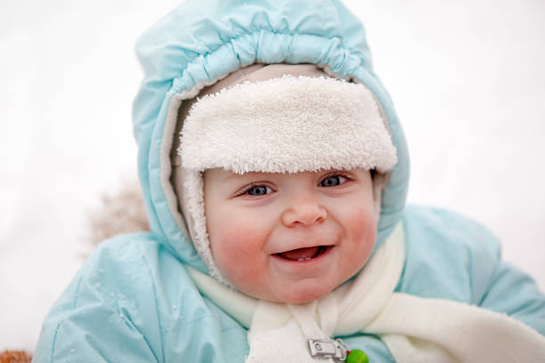 istock Little baby boy in sledge on winter snow day 461979763