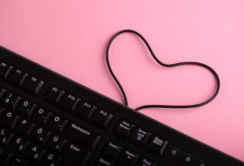 Keyboard and heart shaped cable symbol love on internet