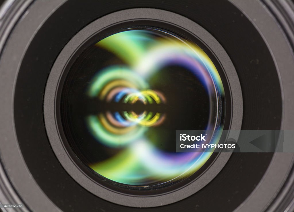 Front element of a camera lens Macro shot of front element of a camera lens with beautiful color lights reflections Abstract Stock Photo