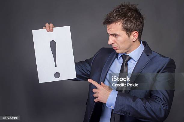 Businessman Holding Exclamation Mark Stock Photo - Download Image Now - A Helping Hand, Adult, Adults Only
