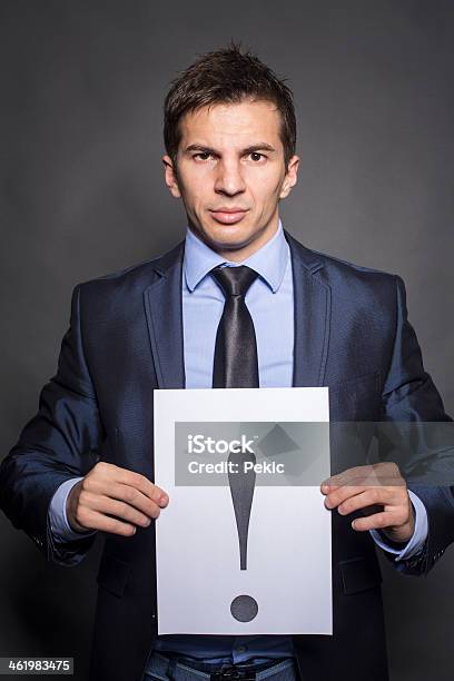 Businessman Holding Exclamation Mark Stock Photo - Download Image Now - A Helping Hand, Adult, Adults Only