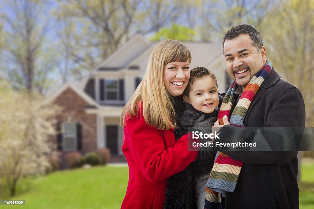 Happy Mixed Race Family in Front of House Happy Mixed Race Young Family in Front of Beautiful House. House Stock Photo