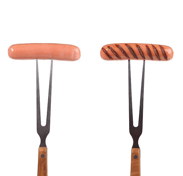 istock Two grilled sausages on the forks. 461993489