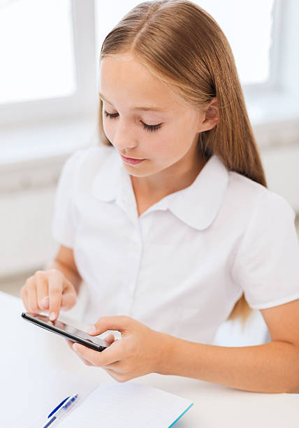 istock girl with smartphone at school 461993955