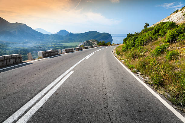 istock Turning mountain highway with sky and sea on a background 461999187