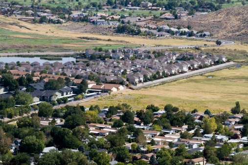 Aerial view of suburban neighborhoods as developments sprawl out into surrounding open areas in Reno, Nevada, USA.