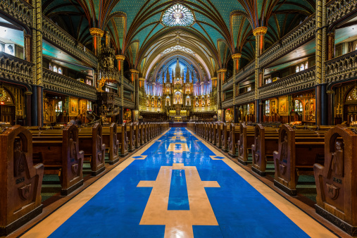 Interior of Notre-Dame cathedral viewed towards its altar, in Montreal, Canada. The church's Gothic Revival architecture is among the most spectacular in the world.