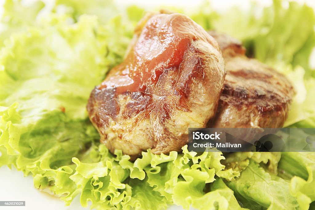 steak with gravy A juicy steak with lettuce and tomato sauce Animal Blood Stock Photo